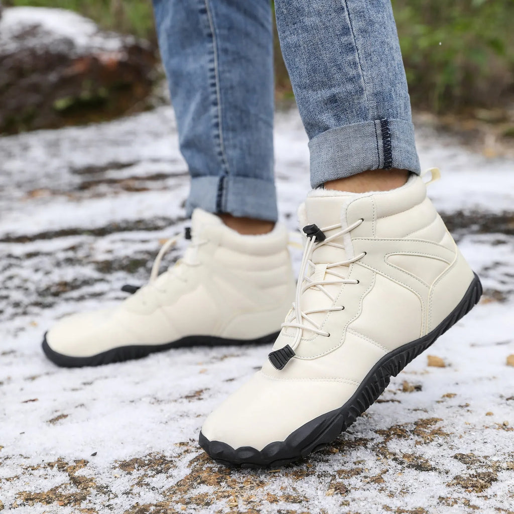 Beige five-finger waterproof snow boots with rubber sole and fleece lining on outdoor ground.