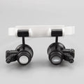 White foldable head-mounted magnifying glass with LED light for 30X precision repair work.