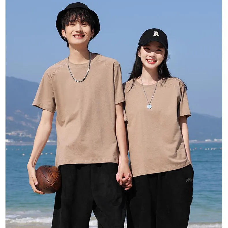 Men's solid colour cotton short sleeve t-shirt laid flat, showing colour options including black, white, and bright orange.