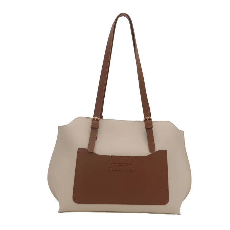 Women's black PU tote bag with shoulder straps showing internal mobile phone pocket