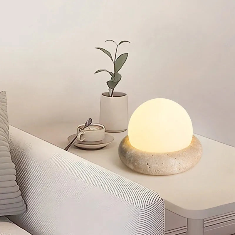 Cream coloured modern bedside night lamp with remote control on wooden table