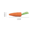 Set of assorted cat toys including fabric carrots, plastic ringing stones, paper crinkles, and wooden grinding sticks