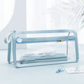 Large transparent double-layer pencil case in blue showing two compartments for exam stationery.