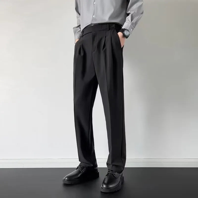 Men's apricot and black straight leg loose fit trousers on a hanger, showing the polyester fabric.