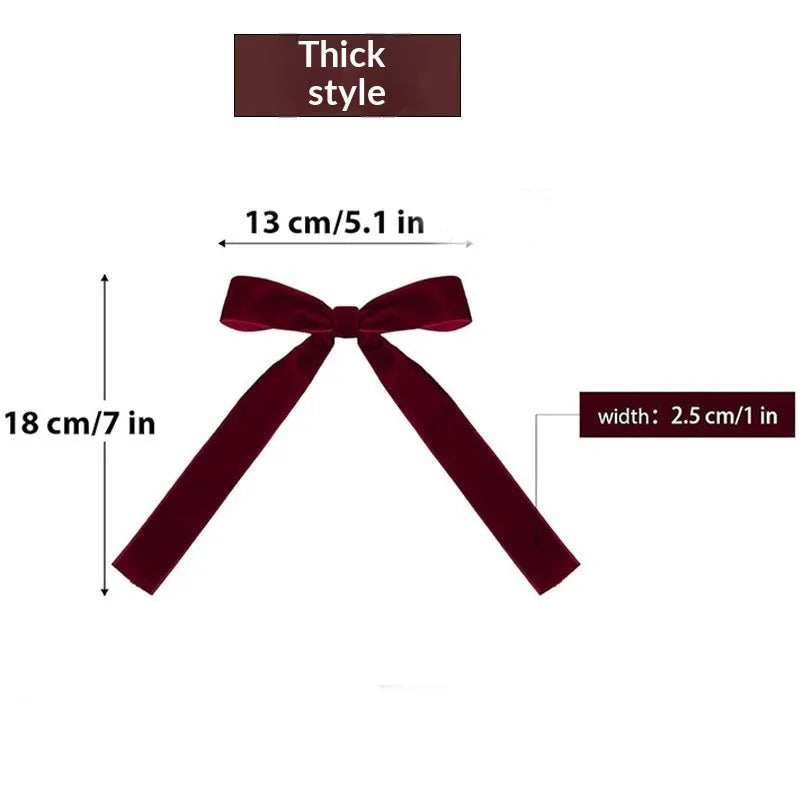 Velvet ribbon Christmas tree strap pendant decoration in a selection of colours including red and gold on a tree branch