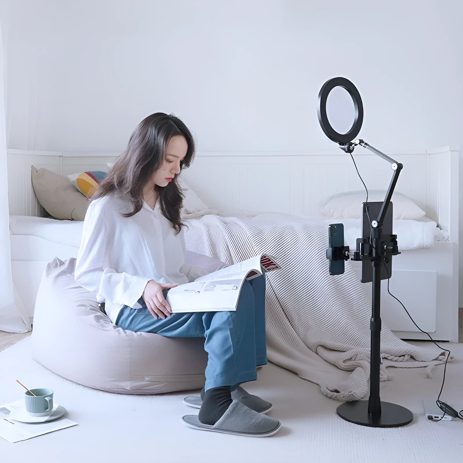 Black aluminium floor stand with fill light holding a mobile phone for video shooting.