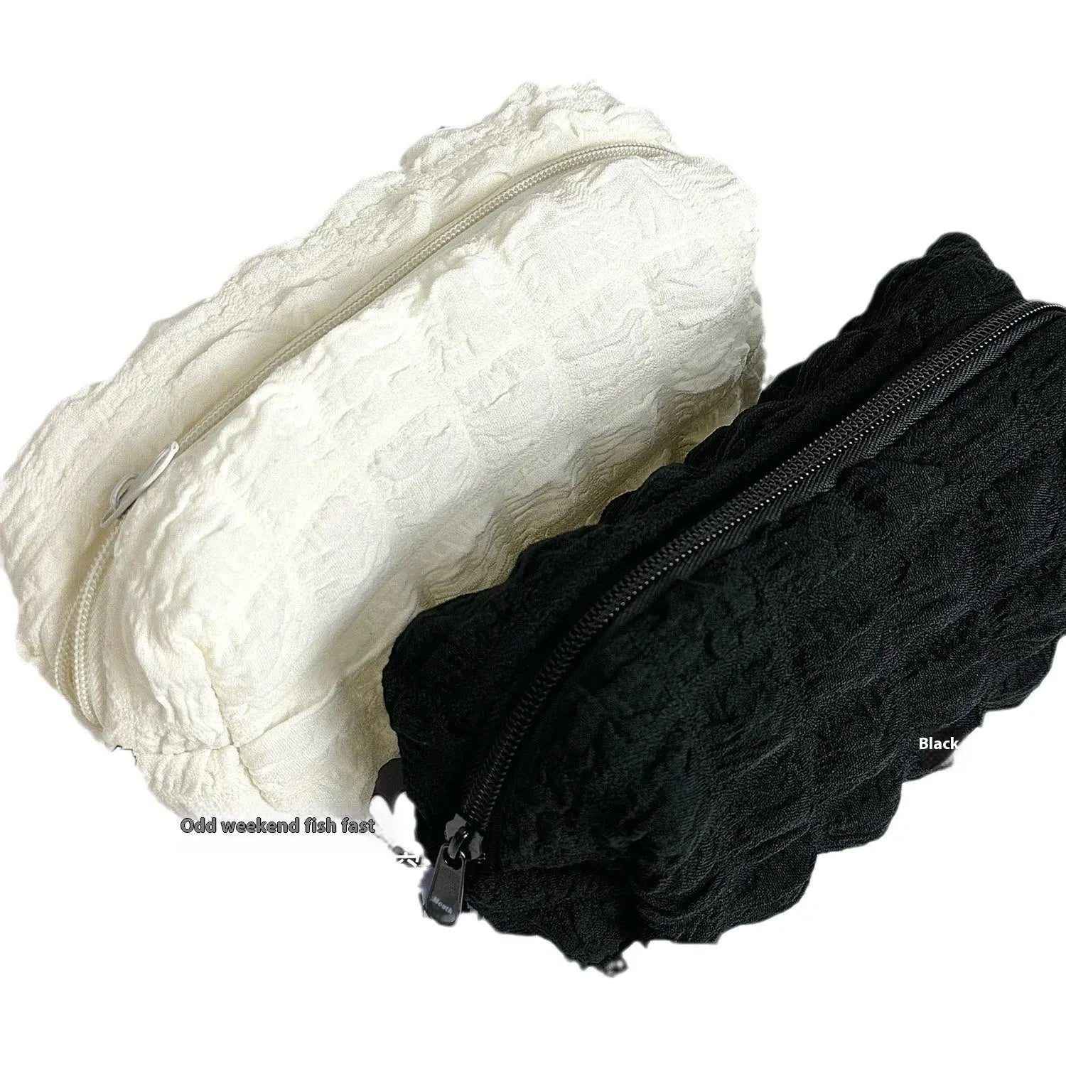 Beige fabric pencil case with a rounded cream puff design next to black version.