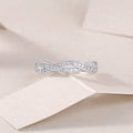 Moissanite wedding ring set in S925 silver with platinum plating on a white background