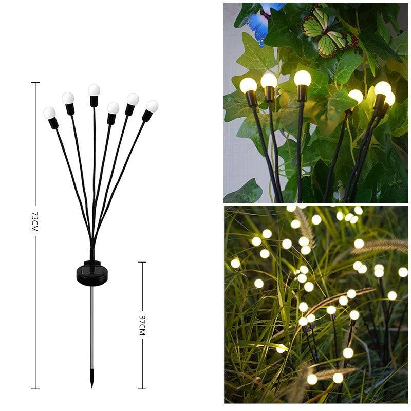 Solar-powered LED pneumatic firefly ground stake light with multiple heads on a grassy lawn.