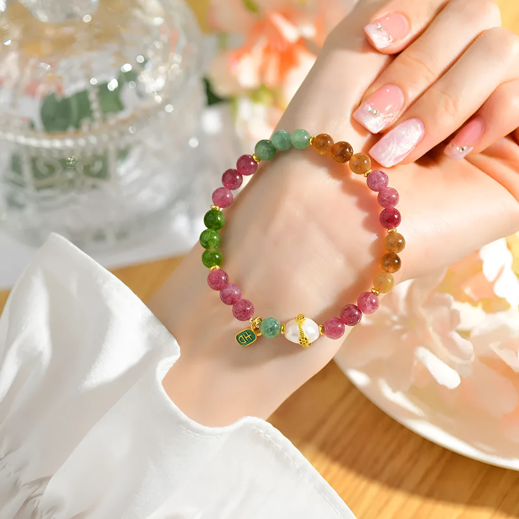 Geometric chalcedony crystal bracelet with 6.5mm beads on a wrist.
