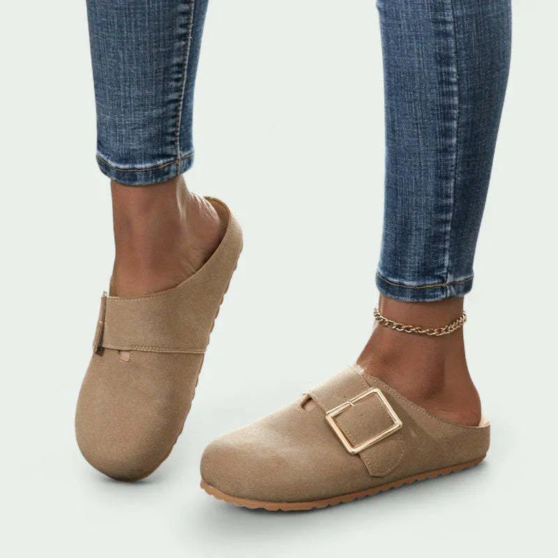 Women's brown closed toe low top canvas slippers shown from the side.