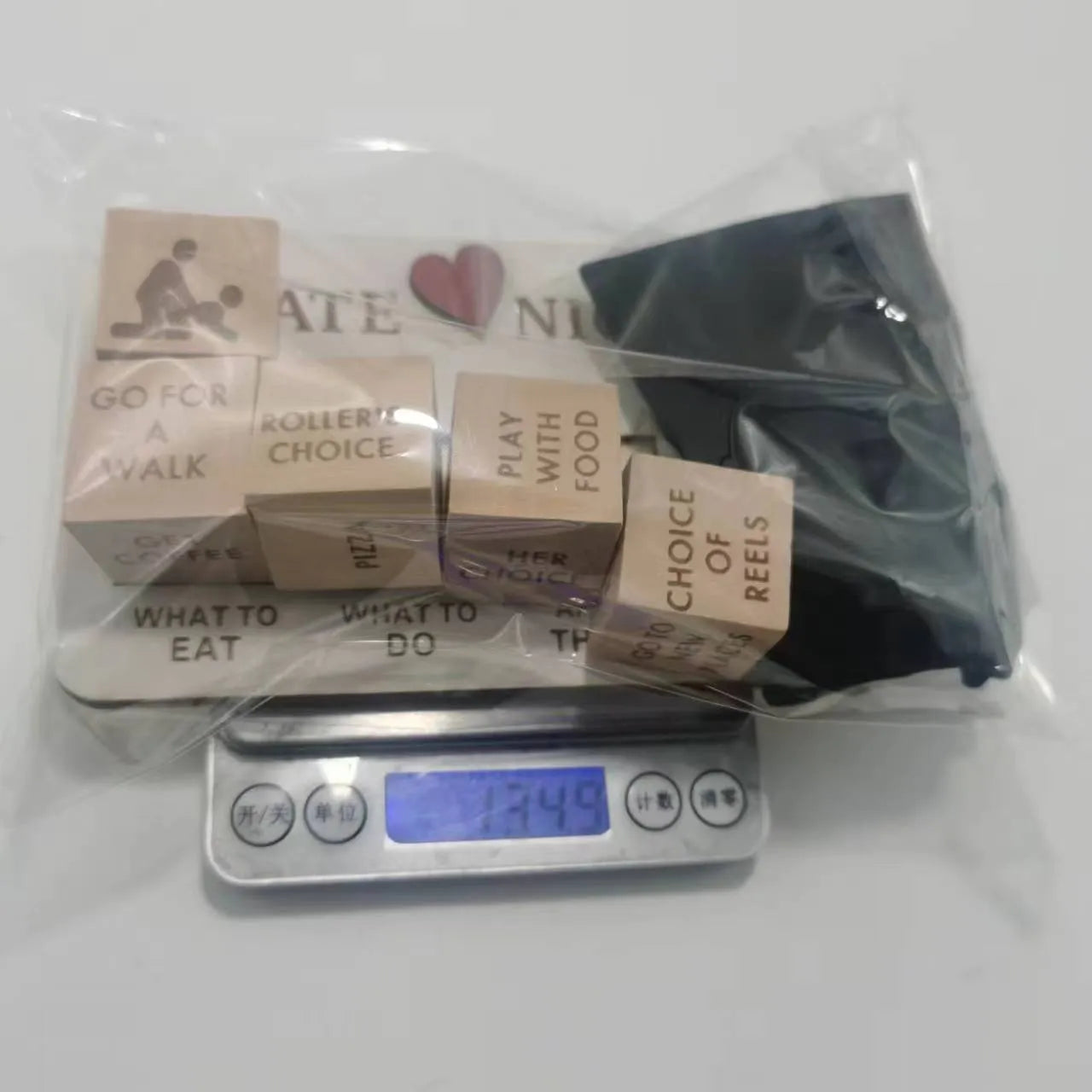 Wooden date night dice set for couples showing five dice, a rectangular planner board, and a black storage bag.