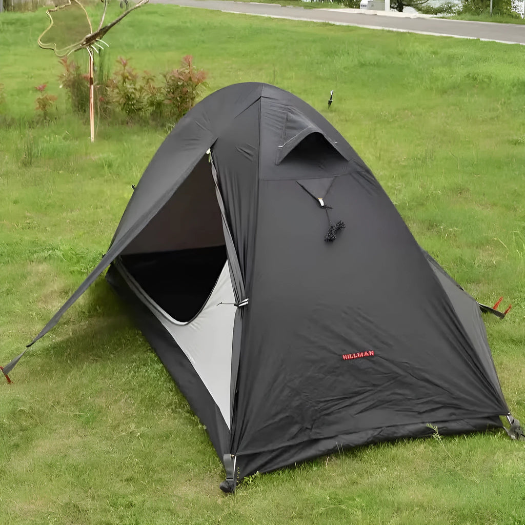 A single person hiking tent with aluminium poles, shown in a black colour option, packed to show its compact size.