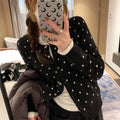 Grey Korean-style loose knitted cardigan with white crocheted flower details on the front.