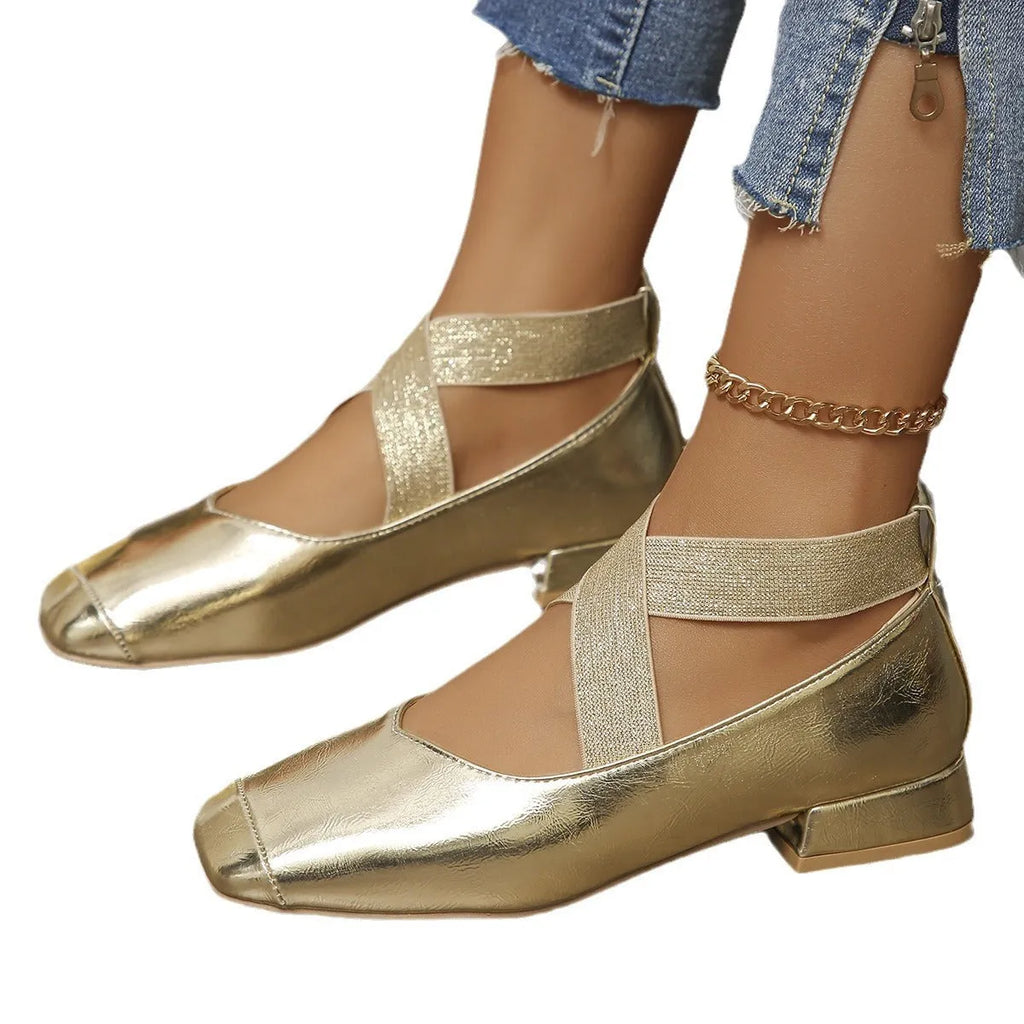 Gold slip-on evening pumps with a flared skirt collar, square toe and low rubber sole.
