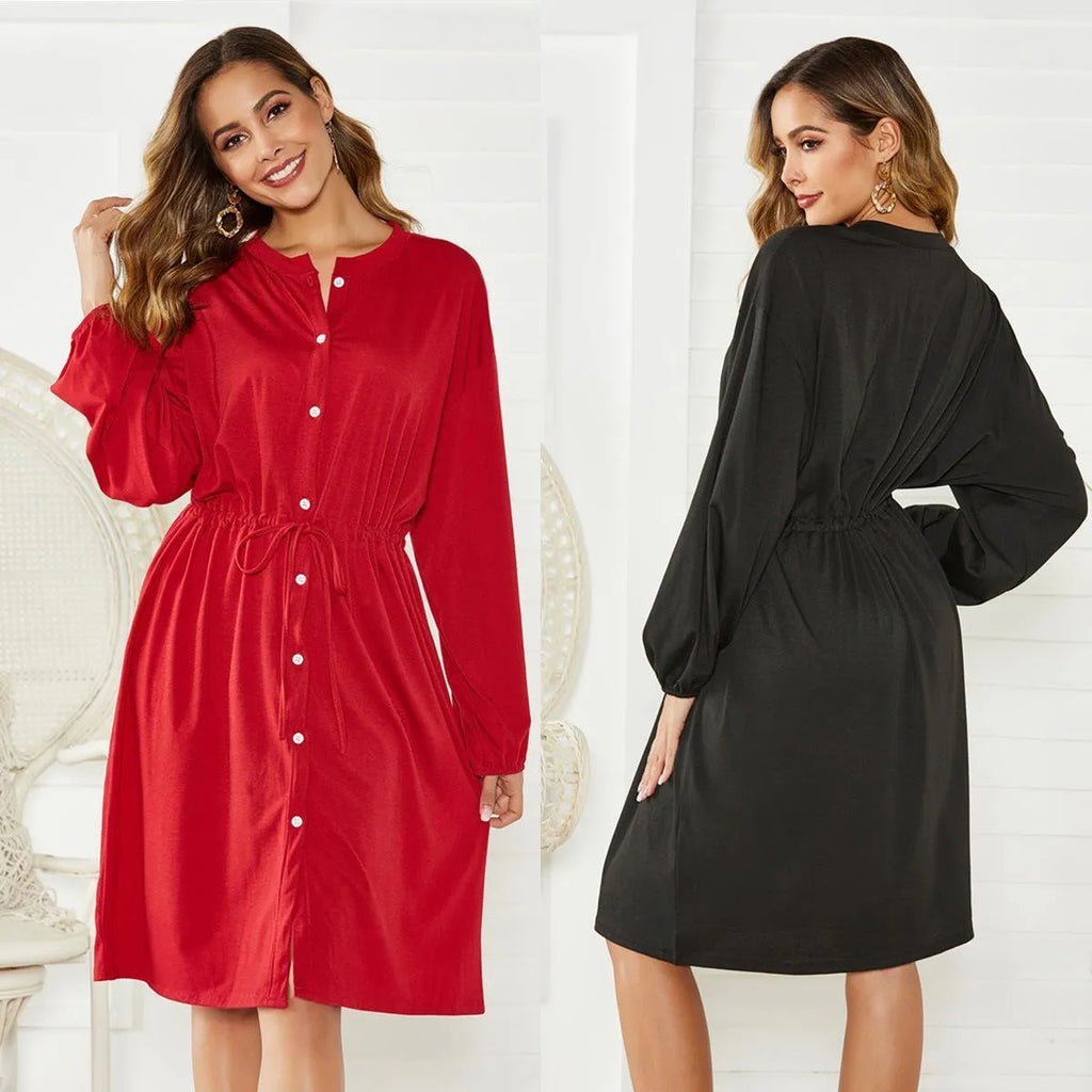 A woman wearing a red mid-length A-line cardigan dress with an elasticated waist and long sleeves.