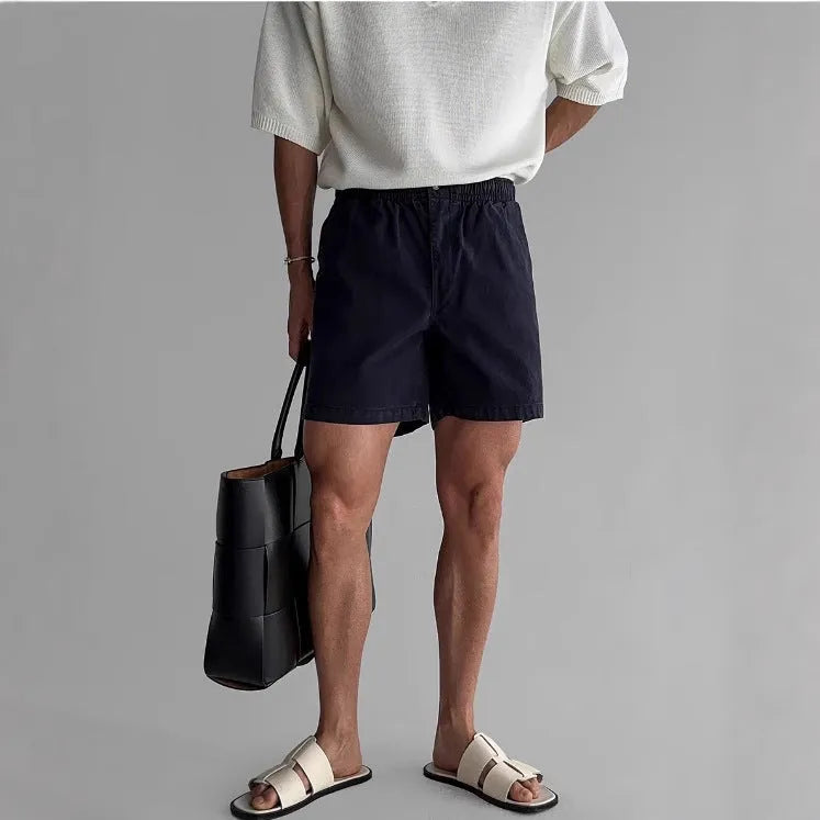 Loose fit cotton sports shorts in black colour on a manikin