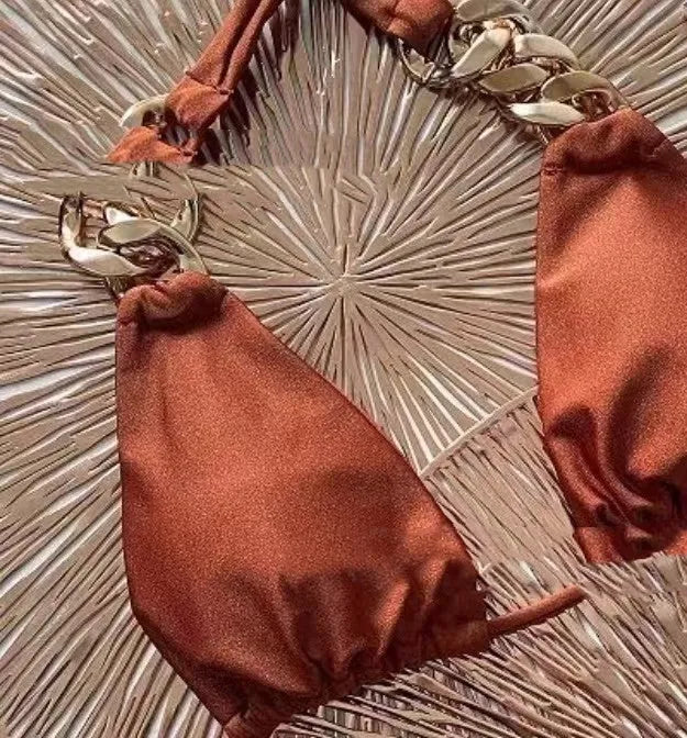 Brown women's tube-top push up bikini swimsuit with split bottom on a mannequin.
