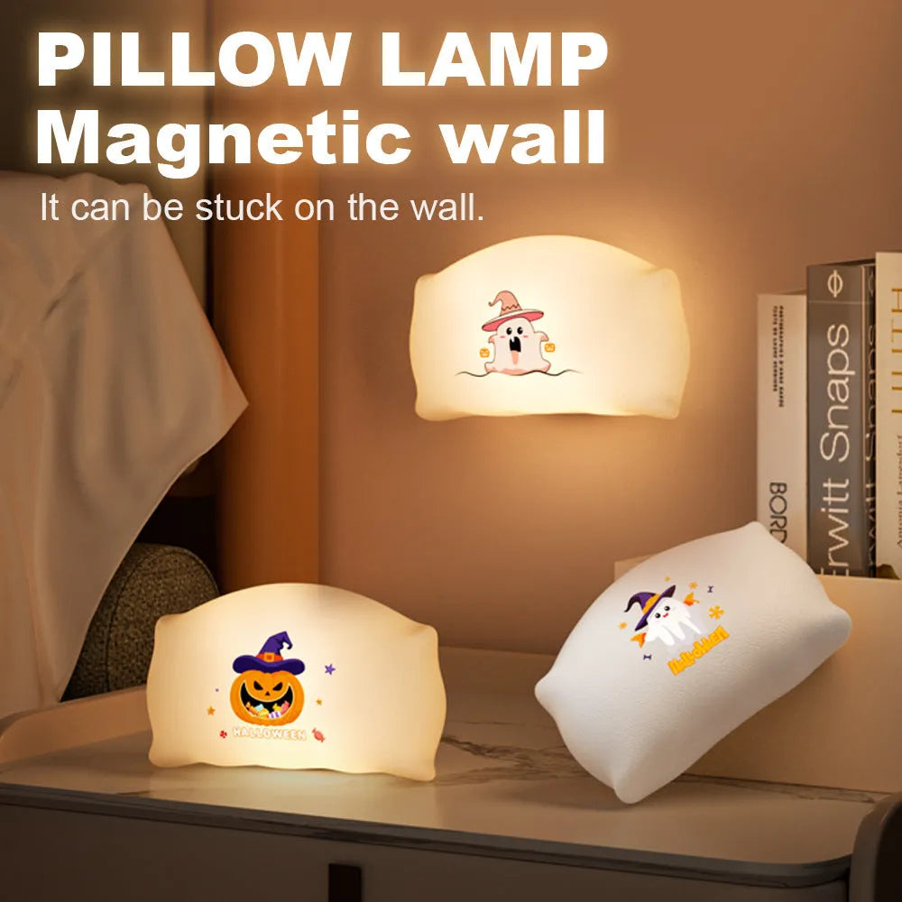 Cartoon Halloween ghost doll table lamp with warm LED light on a bedside table.