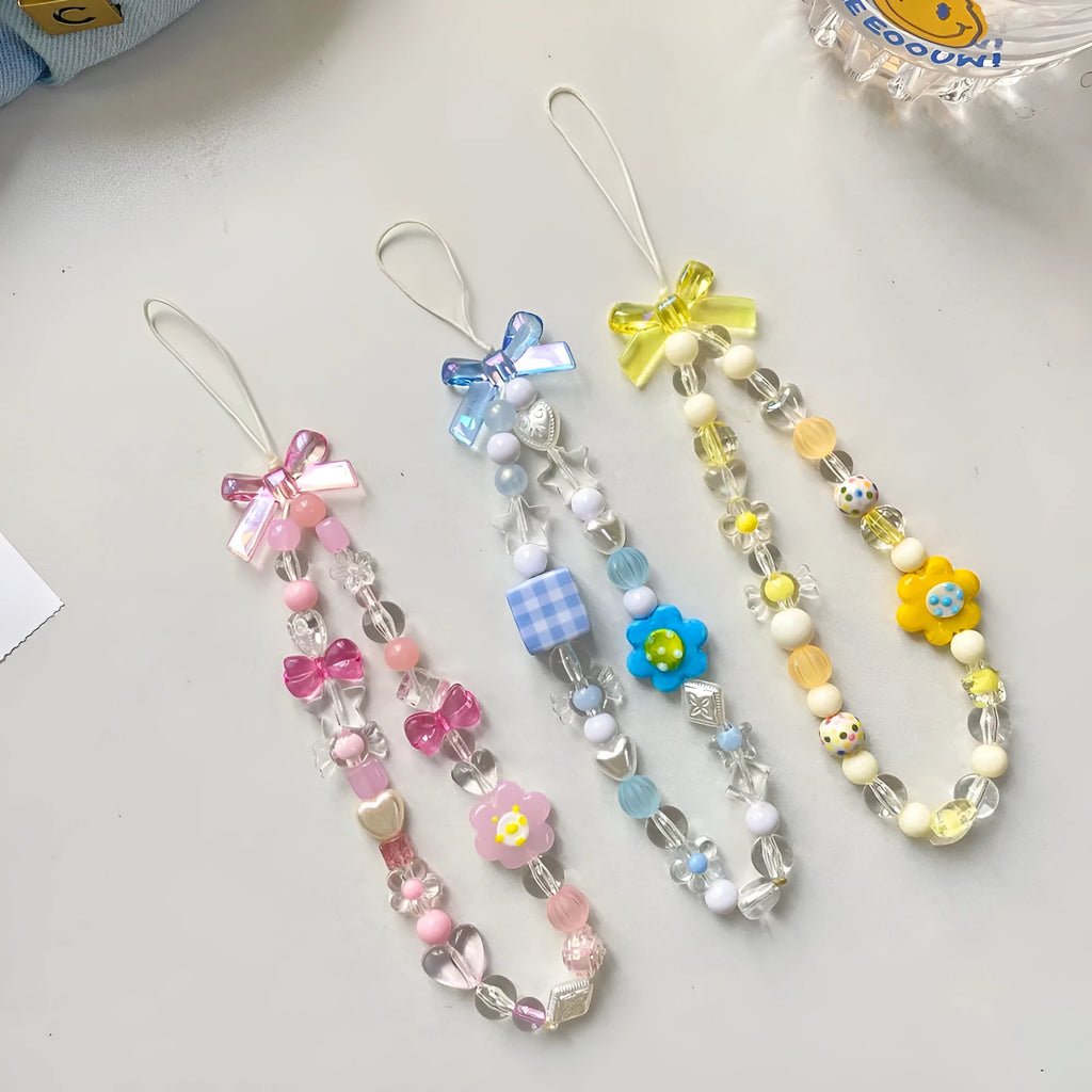 Colourful beaded flower mobile phone lanyard with a hand rope loop in blue, pink, or yellow.