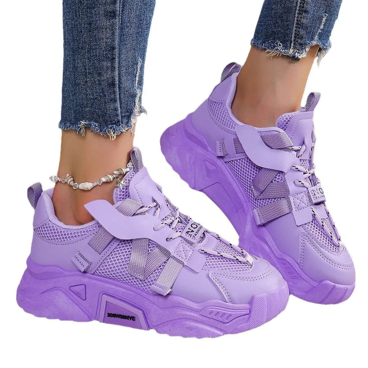 Women's purple platform mesh sports trainer with animal pattern and lace-up front.