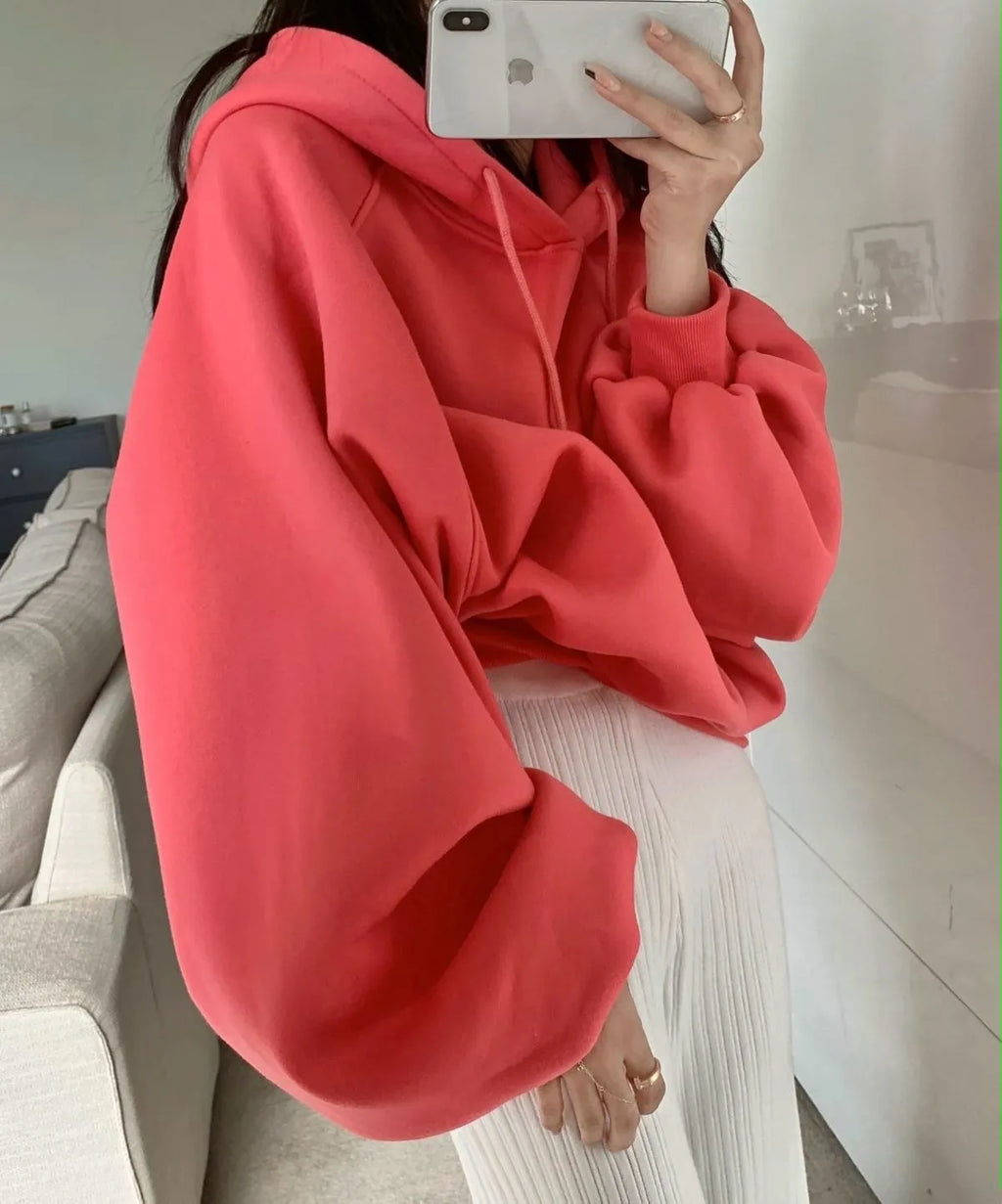 Watermelon red mulberry silk sleeveless hooded sweater for women on a hanger.