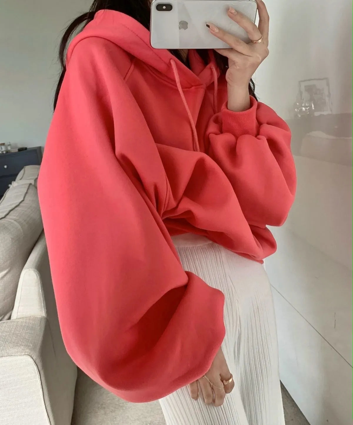 Watermelon red mulberry silk sleeveless hooded sweater for women on a hanger.