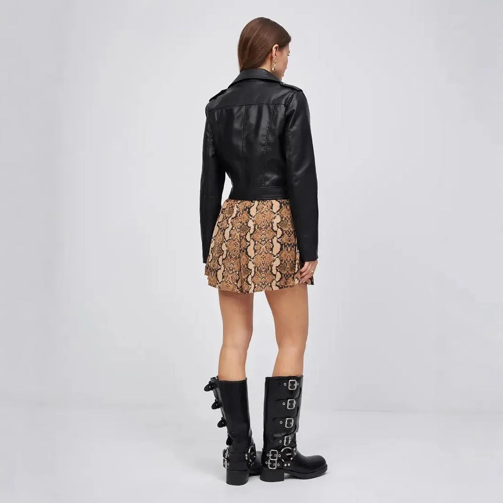 Women's black faux leather retro locomotive jacket with regular sleeves on a hanger.