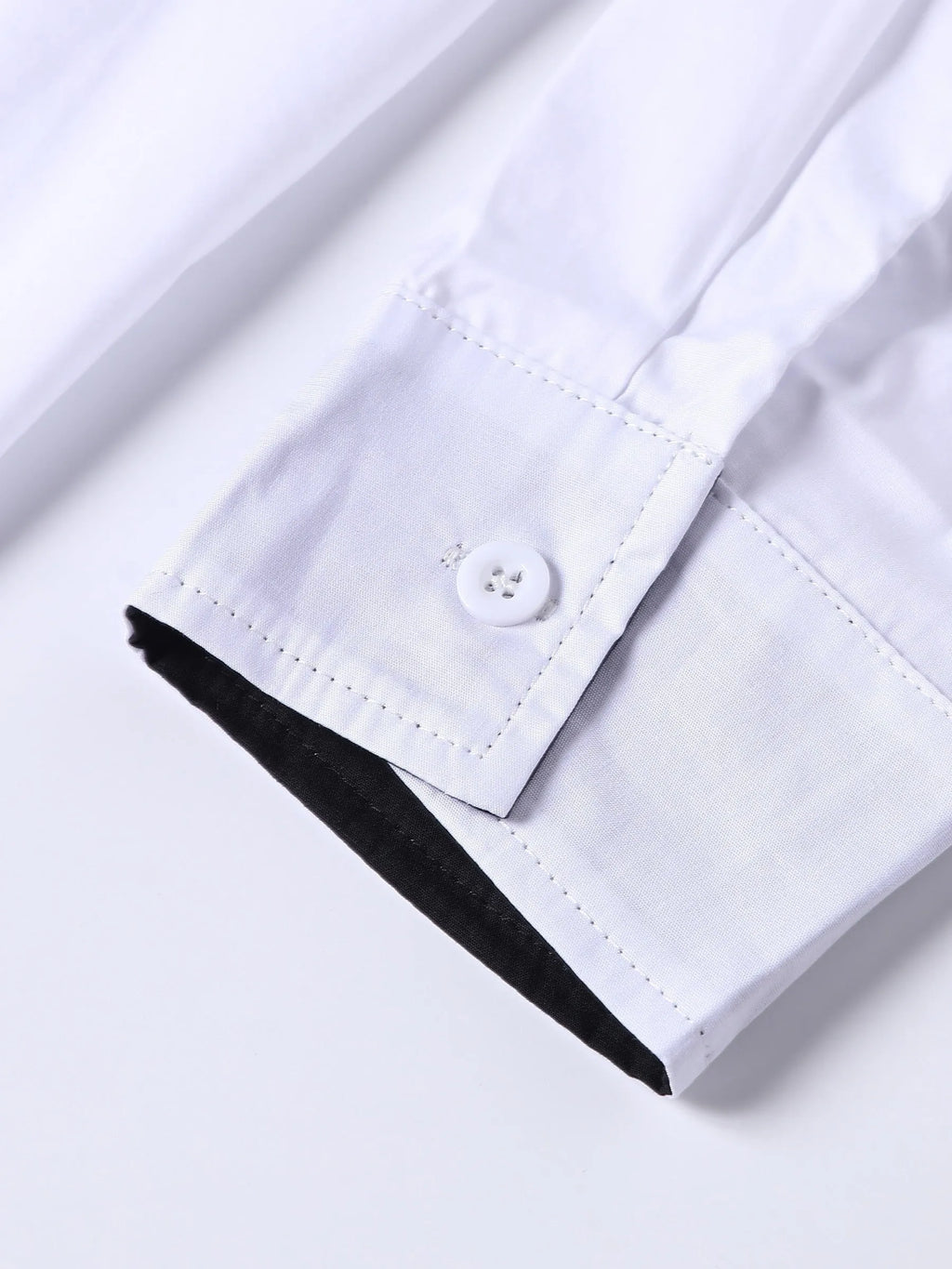 White long-sleeved shirt for teenage men with black contrast collar, cuffs and inner placket, button-down front