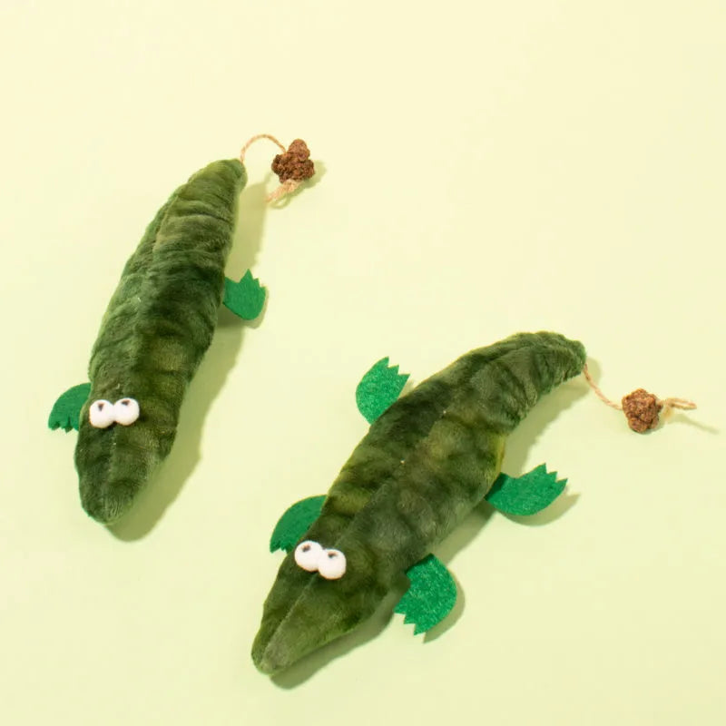 Green plush alligator cat toy with plant based catnip and peppermint scent for oral cleansing