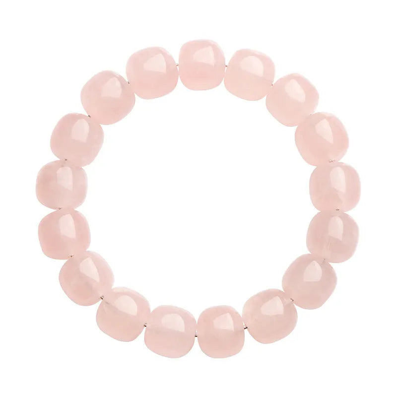 Pink crystal barrel bead bracelet with geometric design on a wrist.
