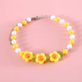 Colourful plastic bead pet necklace for a cat, showing rainbow, peach, and small flower pattern options.