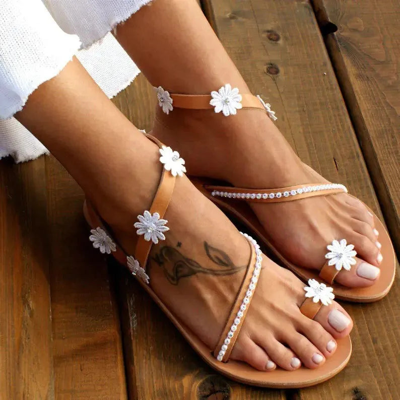 Brown women's Roman sandals with floral decoration and herringbone toe pattern