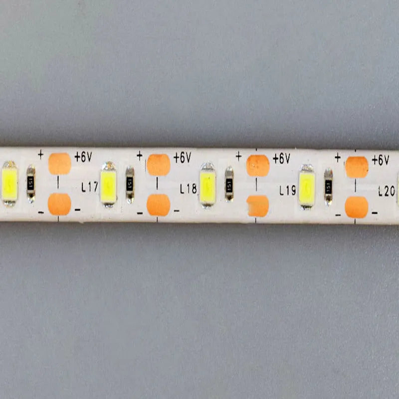 Flexible silicone USB LED light strip bent into a curve, showing touch control button and 3M adhesive backing.