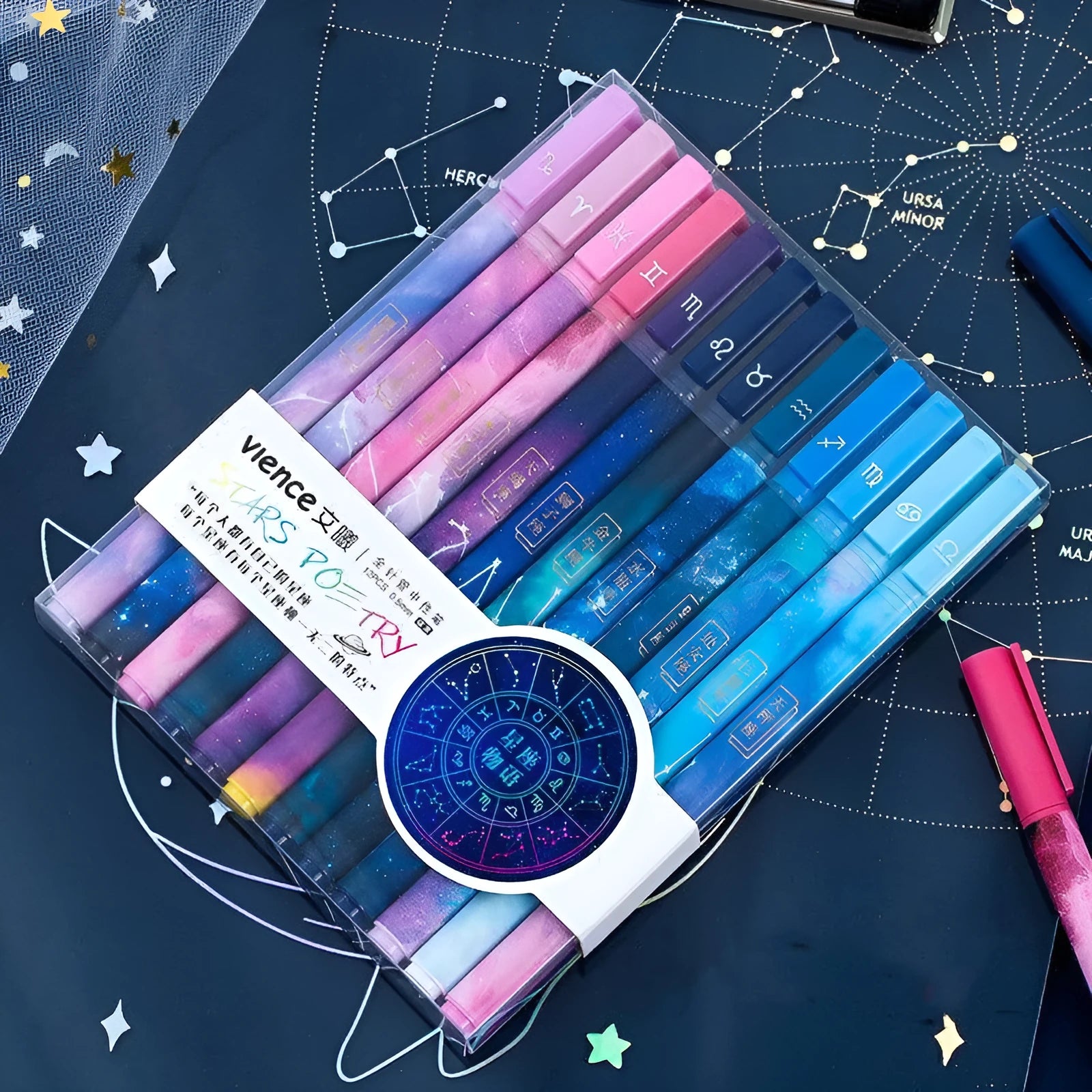 Twelve zodiac constellation ballpoint pens in assorted colours with plastic barrels and star motifs
