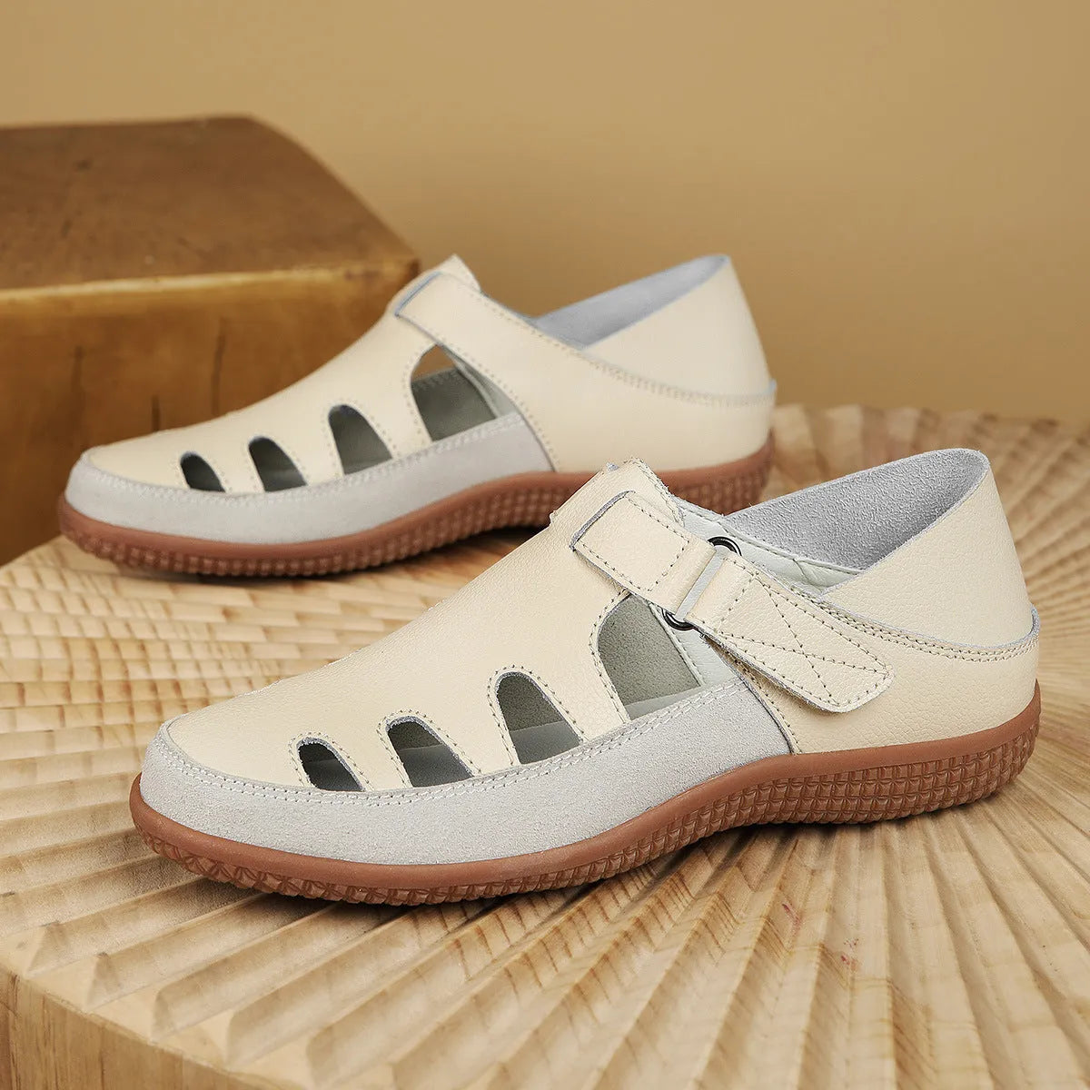 Plus size white women's sandals with hollow toe design and thick flat rubber sole.