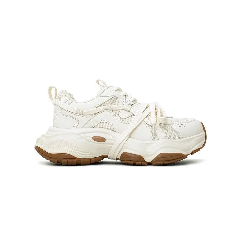 Women's beige platform sneaker with round toe and lace-up front on a white background.