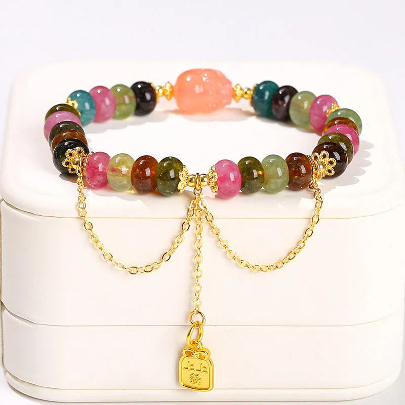 Green crystal bracelet with adjustable string closure on wrist