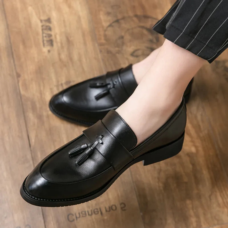 Men's black slip-on business casual shoes with tassel detailing and rubber sole