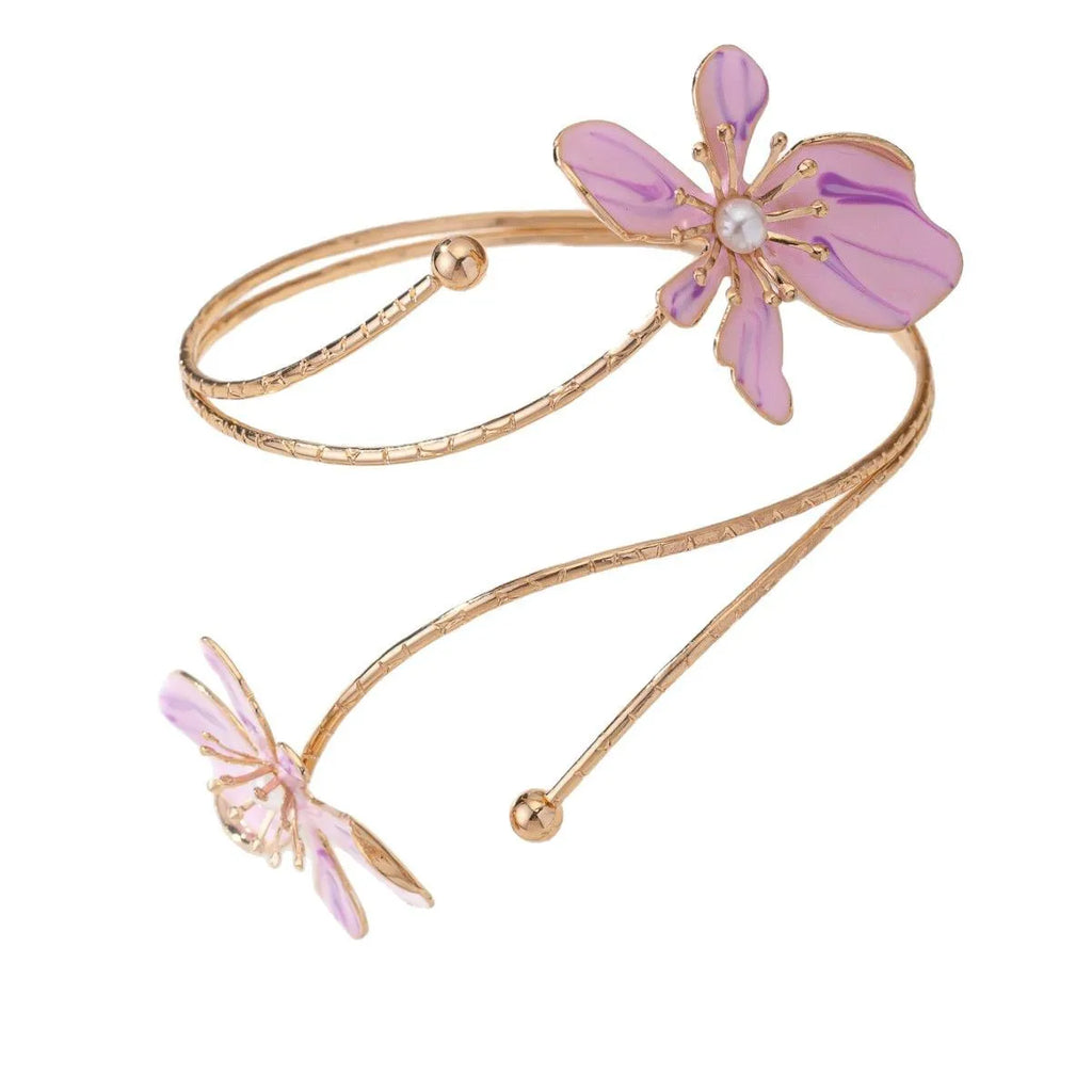 Close-up of a pink hollow patterned alloy armband for women's fashion.