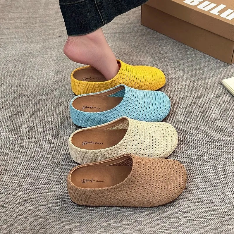 Women's blue cloth slippers with round toe and non-slip rubber sole, shown from the side.