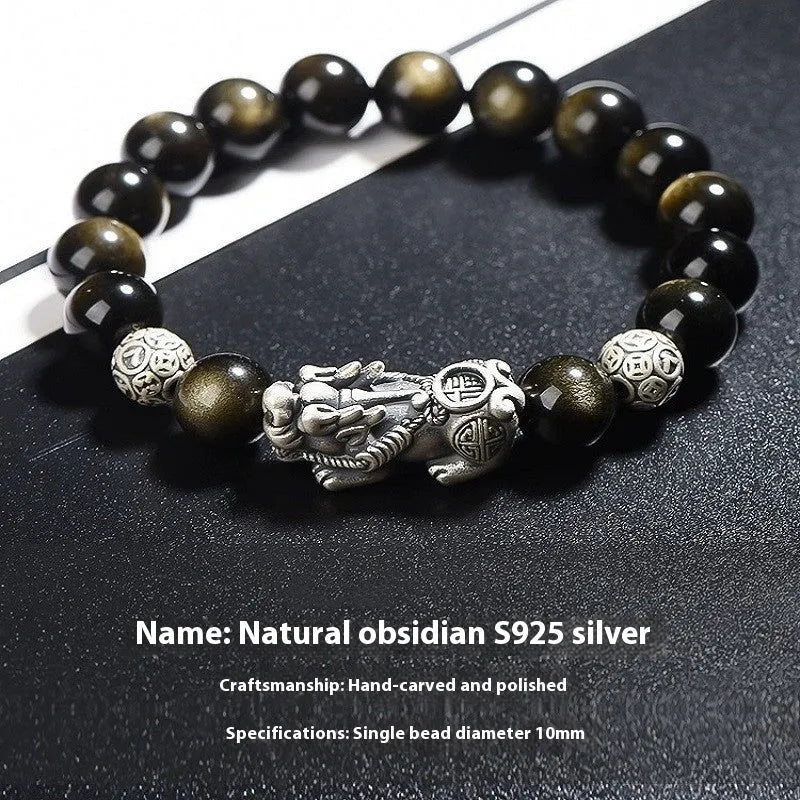 Men's geometric bracelet with a polished obsidian bead and 999 sterling silver on a leather strap.