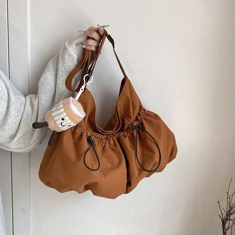Green ultra-light pleated polyester crossbody bag with a split pocket, shown folded and open.