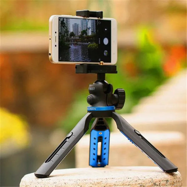 Black desktop mobile phone tripod stand holding a phone, showing adjustable angle bracket.