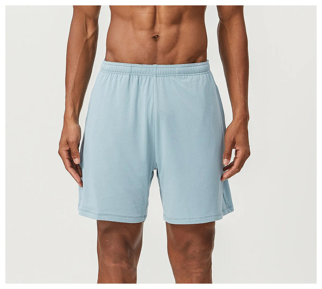 Man wearing sky green quick-drying double-layer running shorts for exercise.
