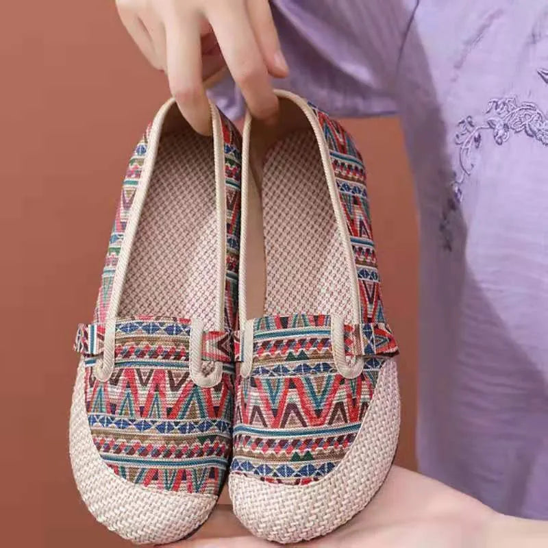 Women's ethnic style flat heel cloth shoes with colour stitching and shallow mouth design.