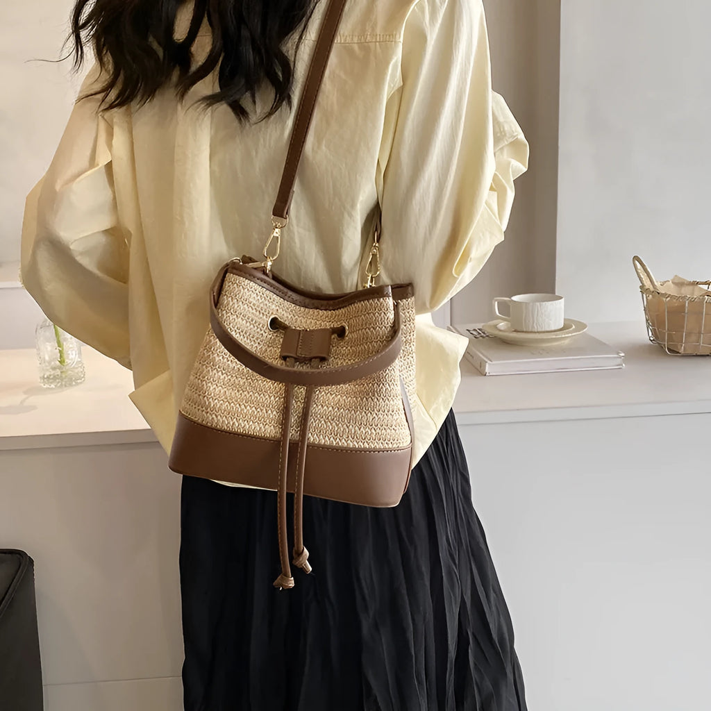 Woven straw women's crossbody bucket bag in horizontal square shape with adjustable shoulder strap