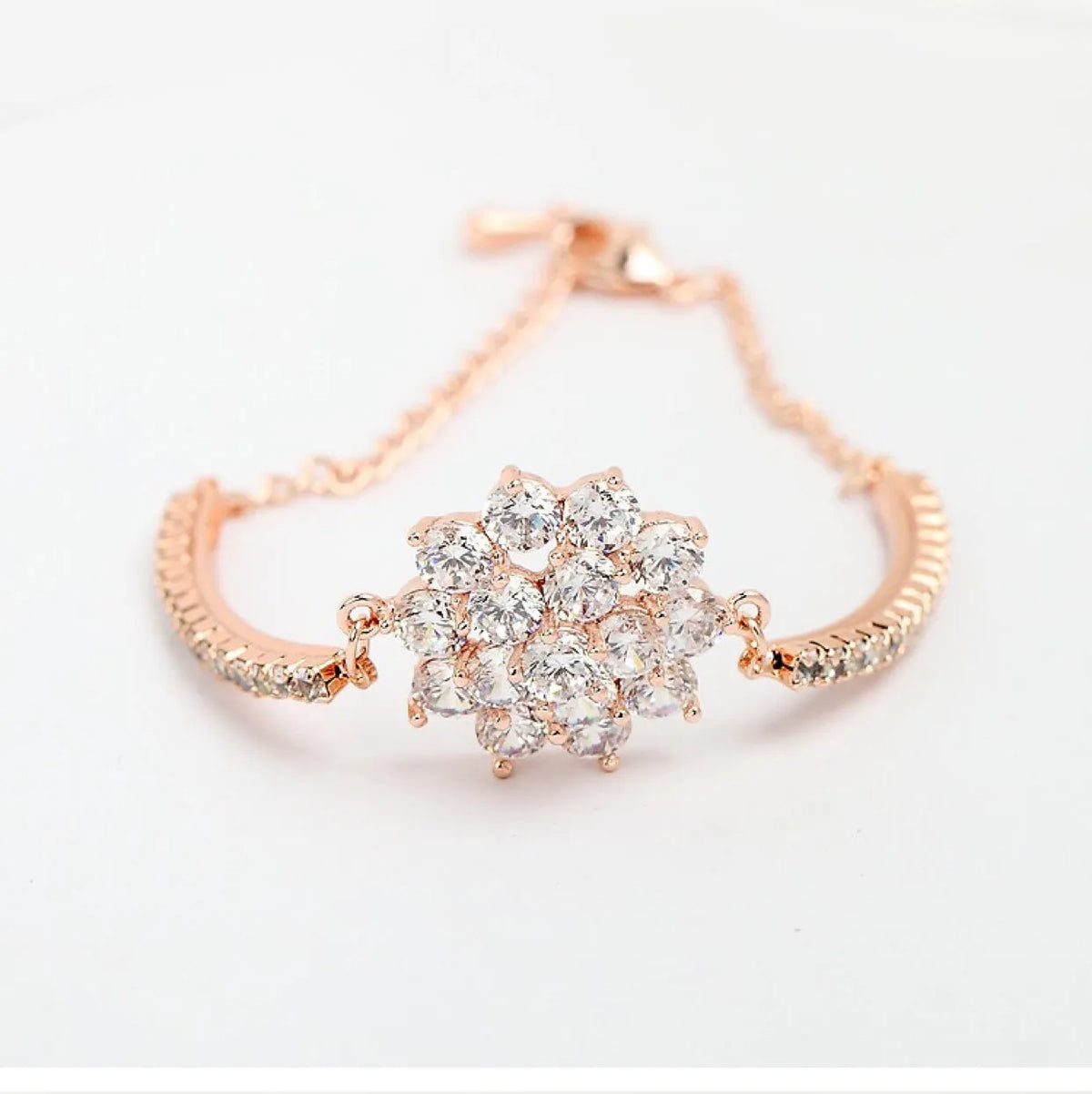 Rose gold cubic zirconia bracelet for women with adjustable 13-19cm length and cross, crown or Roman numeral design.