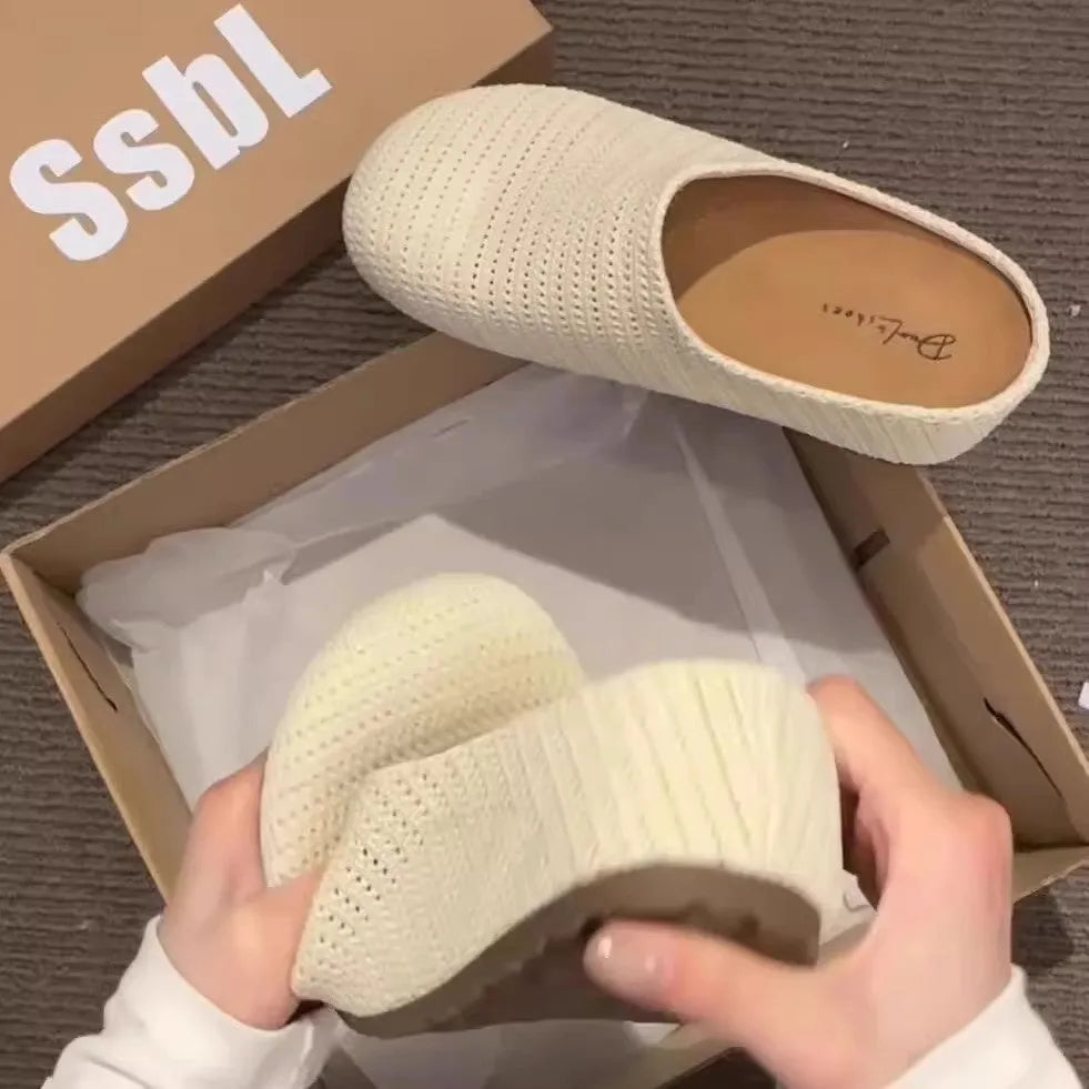 Women's blue cloth slippers with round toe and non-slip rubber sole, shown from the side.