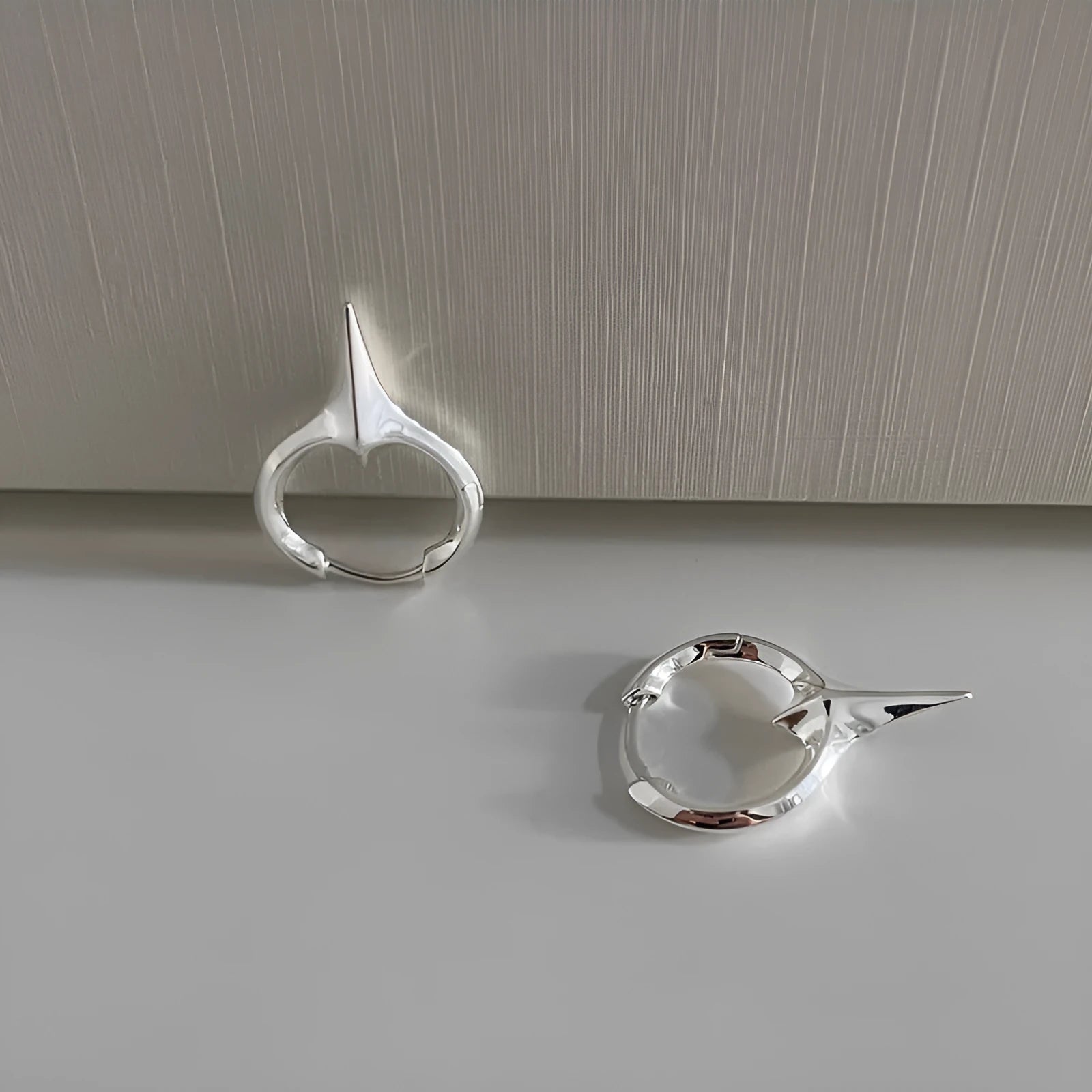 Geometric star-shaped ear clips for women with platinum electroplated finish on copper base